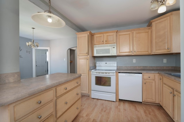 kitchen with light hardwood / wood-style floors, an inviting chandelier, pendant lighting, and white appliances