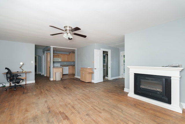 unfurnished living room featuring ceiling fan and light wood-type flooring