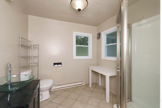 bathroom featuring toilet, baseboard heating, vanity, and tile patterned floors