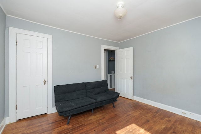 sitting room with hardwood / wood-style flooring and ornamental molding