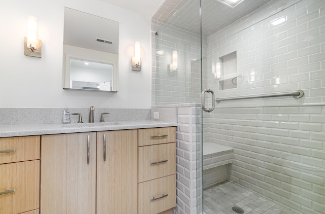 bathroom featuring an enclosed shower and vanity