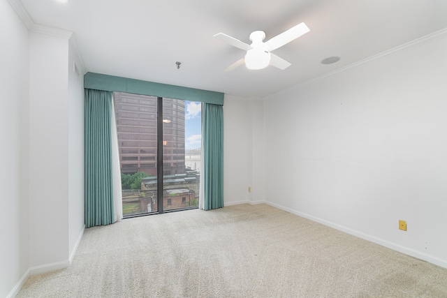 unfurnished room featuring ceiling fan, ornamental molding, and light carpet