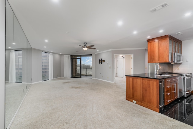 kitchen featuring ceiling fan, backsplash, dark colored carpet, crown molding, and stainless steel appliances