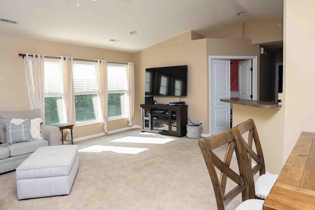 living room with light colored carpet and lofted ceiling