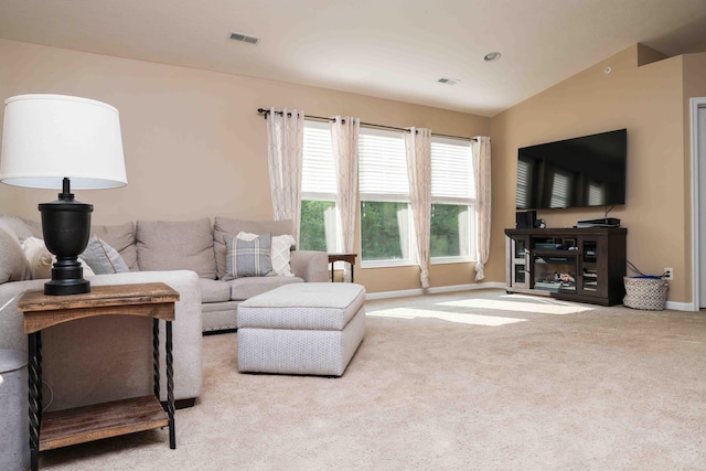 carpeted living room featuring vaulted ceiling