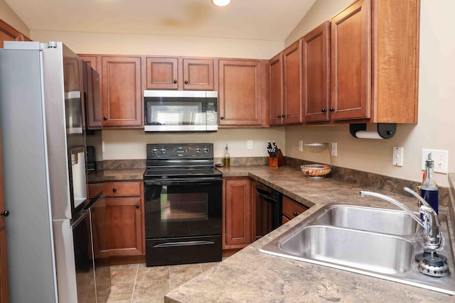 kitchen featuring sink, lofted ceiling, light tile patterned floors, and black appliances