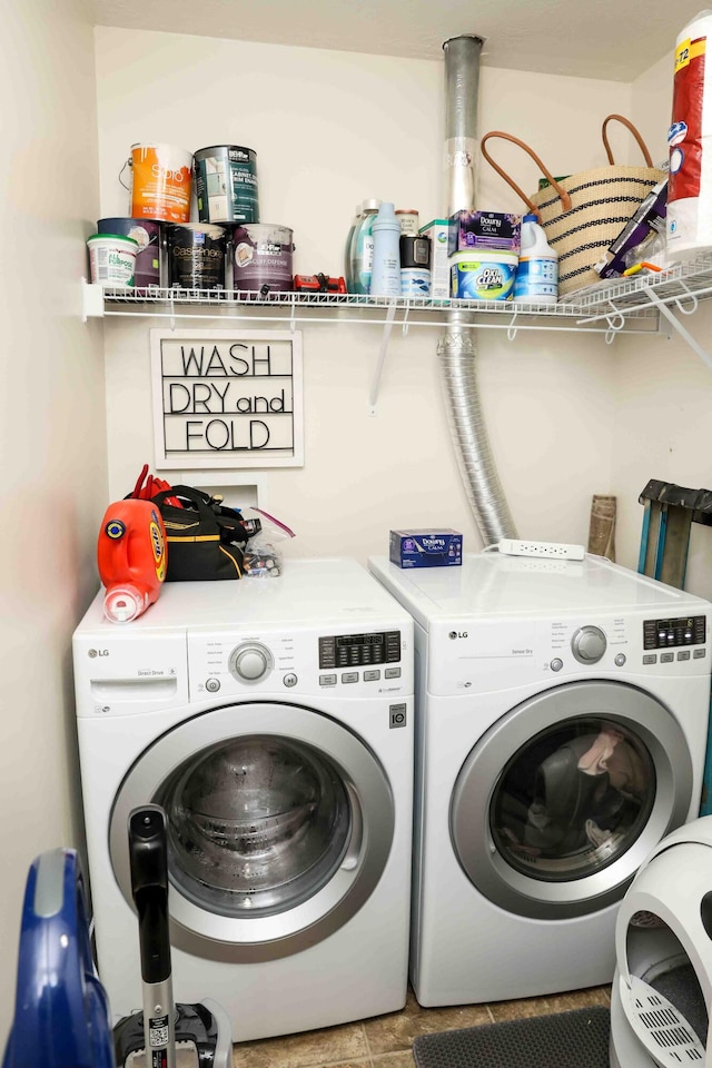 clothes washing area featuring independent washer and dryer and light tile patterned flooring