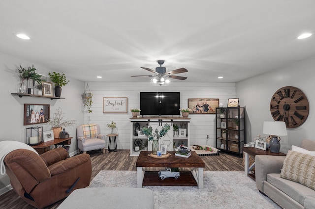 living room with a ceiling fan, recessed lighting, a fireplace, and wood finished floors