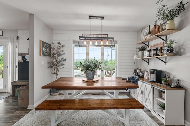 dining room with baseboards and dark wood-type flooring