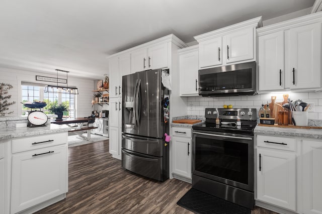 kitchen featuring appliances with stainless steel finishes, dark wood-style flooring, white cabinets, and decorative backsplash