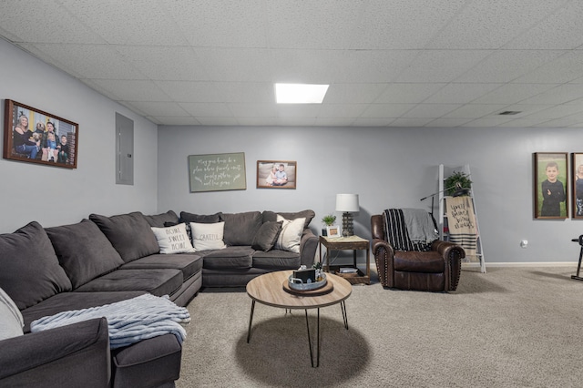 carpeted living room featuring electric panel, baseboards, and a drop ceiling