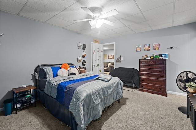 bedroom featuring baseboards, carpet floors, a paneled ceiling, and a ceiling fan