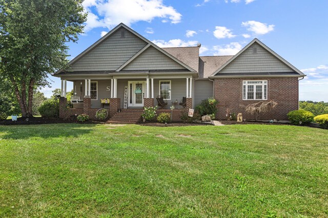 craftsman-style home featuring a porch and a front yard