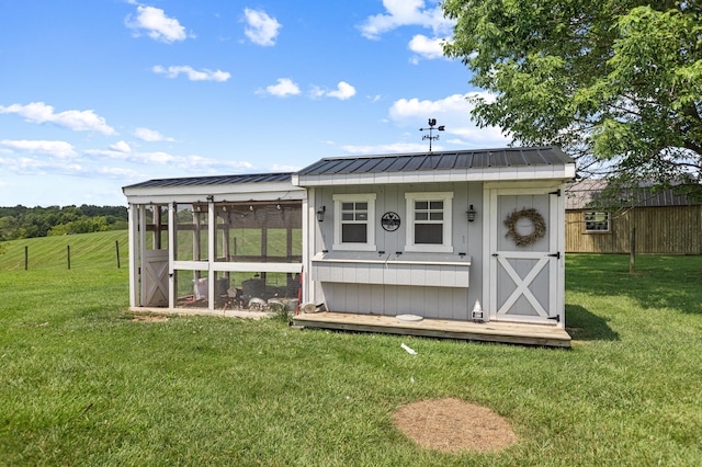 view of poultry coop featuring a yard, a rural view, and fence