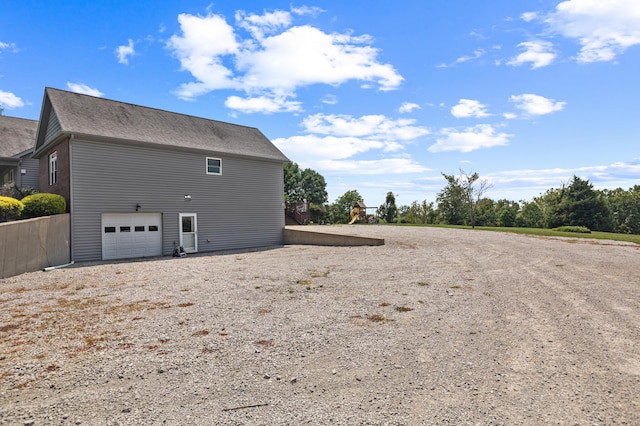 view of side of home featuring an attached garage