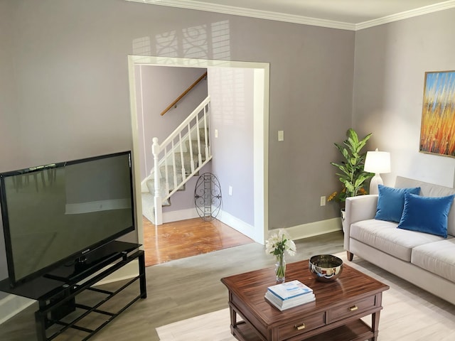 living room featuring light wood-type flooring and ornamental molding