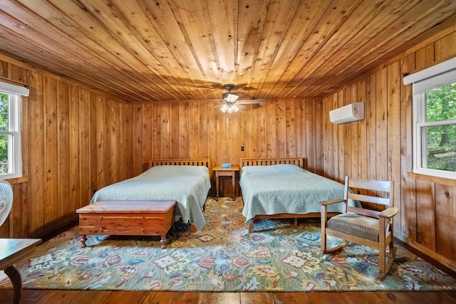 bedroom featuring wood ceiling, hardwood / wood-style floors, a wall mounted air conditioner, and wooden walls