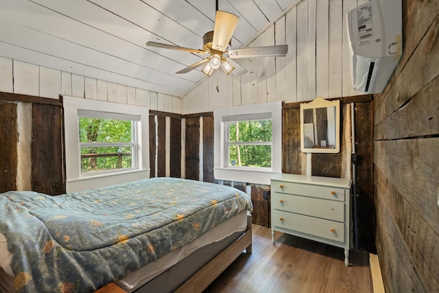 bedroom with multiple windows, ceiling fan, and wooden walls