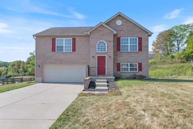 raised ranch with a front yard and a garage