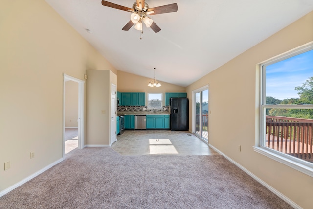 unfurnished living room with light colored carpet, ceiling fan with notable chandelier, and vaulted ceiling