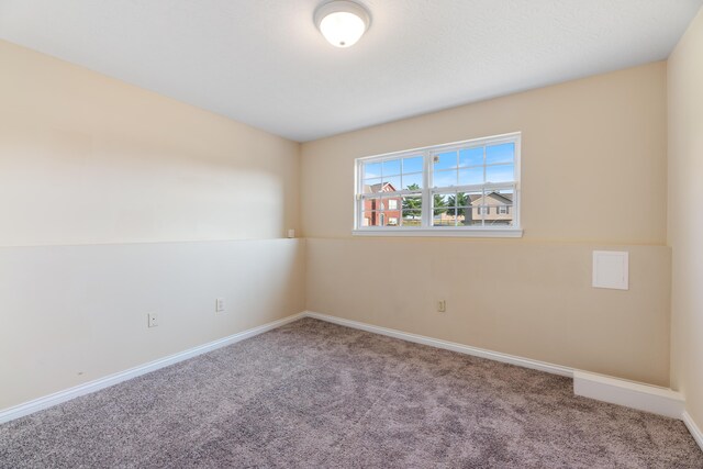 carpeted spare room featuring lofted ceiling