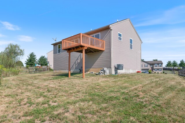 back of property with a lawn and cooling unit