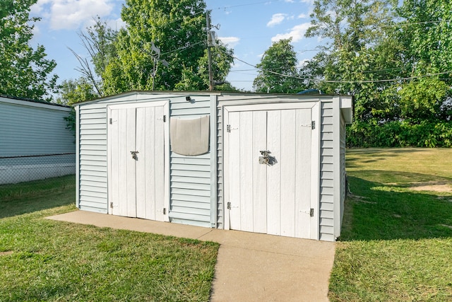 view of outdoor structure with a lawn