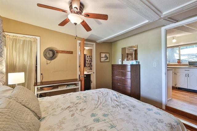 bedroom featuring connected bathroom, ceiling fan, and hardwood / wood-style flooring