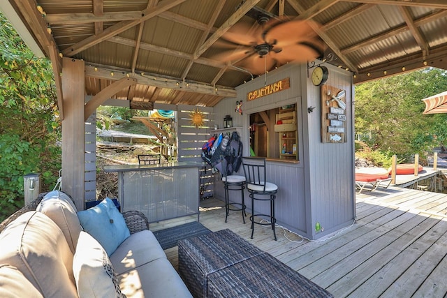 wooden deck featuring an outdoor living space, ceiling fan, and a gazebo