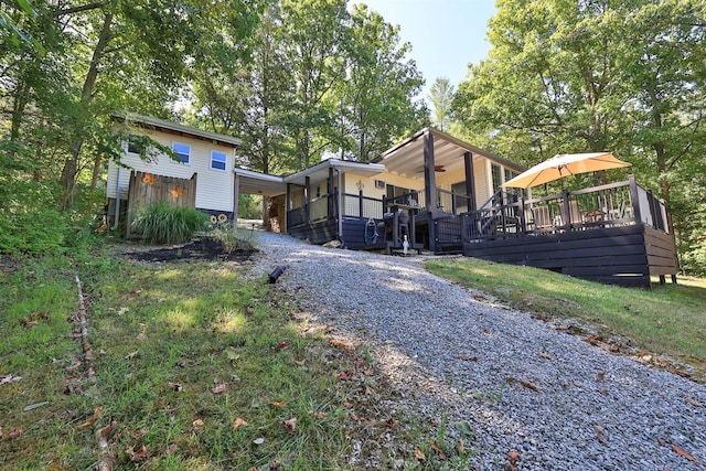 view of home's exterior featuring gravel driveway and a deck