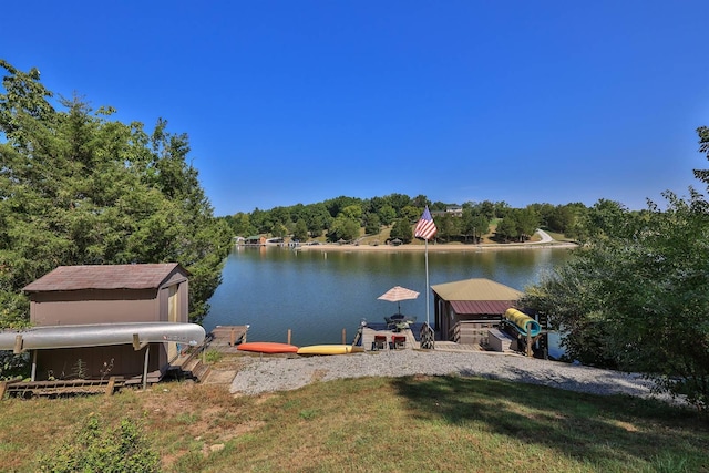 dock area with a water view and a lawn