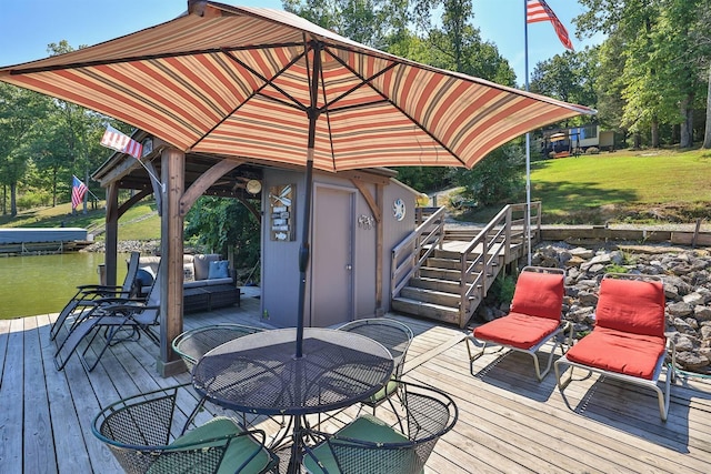 wooden deck with a yard and a storage unit