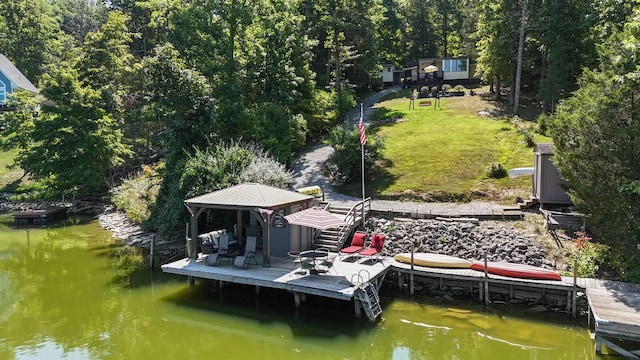 dock area featuring a gazebo, a lawn, and a water view