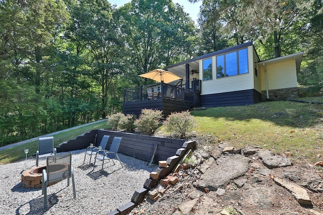 view of yard with an outdoor fire pit and a deck