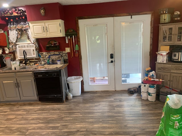 kitchen with a textured ceiling, black dishwasher, cooling unit, hardwood / wood-style flooring, and white cabinets