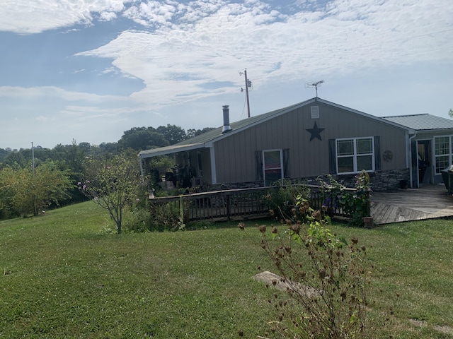 view of property exterior featuring a yard and a wooden deck