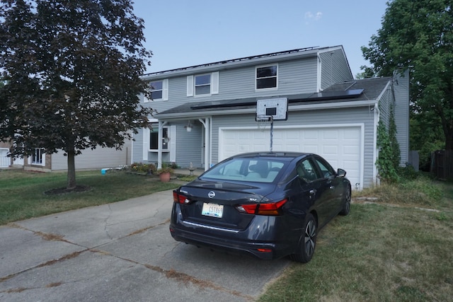 front facade with a garage and a front yard