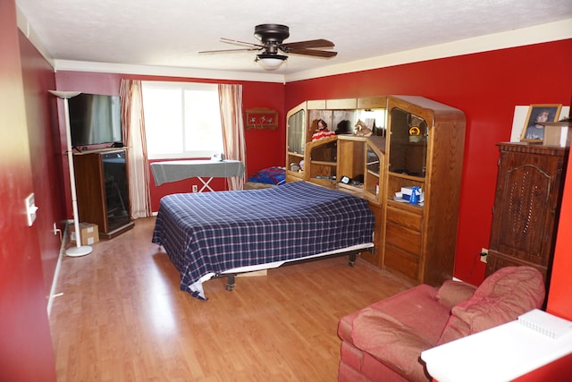 bedroom featuring a textured ceiling, ceiling fan, and hardwood / wood-style floors