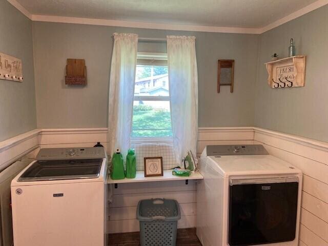 laundry room featuring ornamental molding and washer and clothes dryer