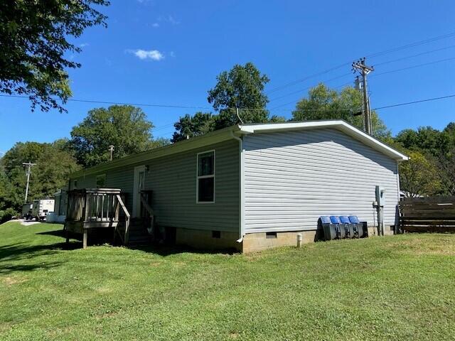 view of side of home featuring a lawn