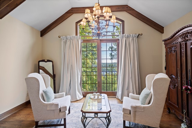 living area with lofted ceiling, a chandelier, and hardwood / wood-style floors