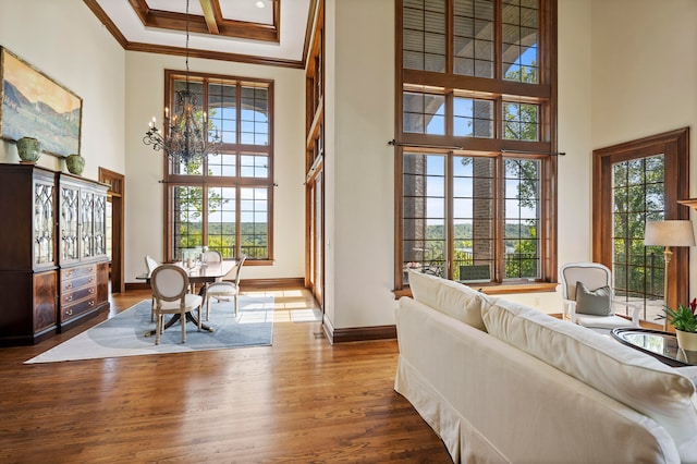 interior space featuring crown molding, hardwood / wood-style floors, and a healthy amount of sunlight