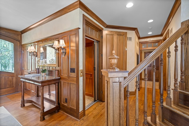 entrance foyer with light wood-type flooring and ornamental molding