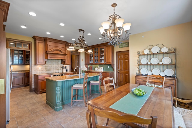 dining room featuring a notable chandelier and sink