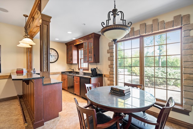 interior space featuring black dishwasher, a breakfast bar area, sink, and kitchen peninsula