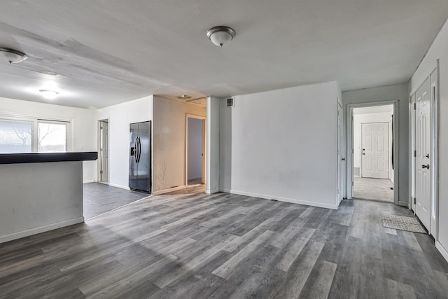 unfurnished living room with dark hardwood / wood-style floors