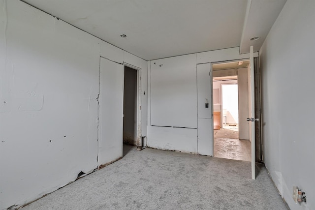 unfurnished bedroom with light colored carpet