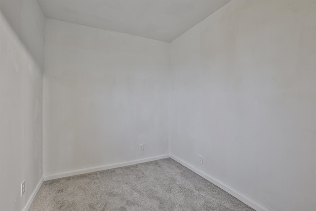 unfurnished room featuring light carpet