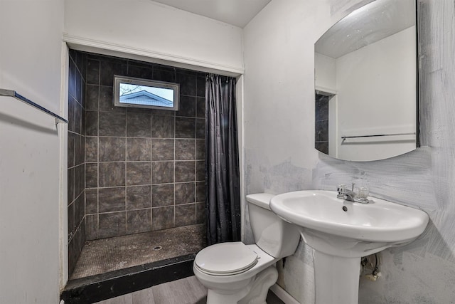 bathroom featuring a shower with shower curtain, hardwood / wood-style floors, and toilet