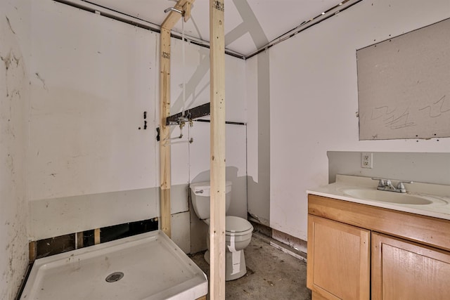 bathroom featuring vanity, toilet, and concrete flooring